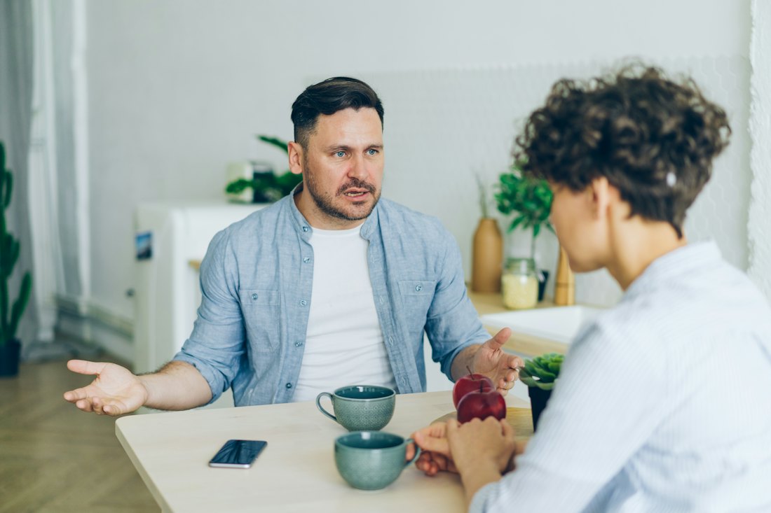 A couple having an honest conversation at the kitchen table